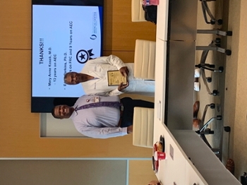 Dr. Demondes Haynes, Associate Dean for Admissions, thanks Dr. Eddie Perkins for nine years of service on the Admissions Executive Committee and four years of service on the File Review Committee.